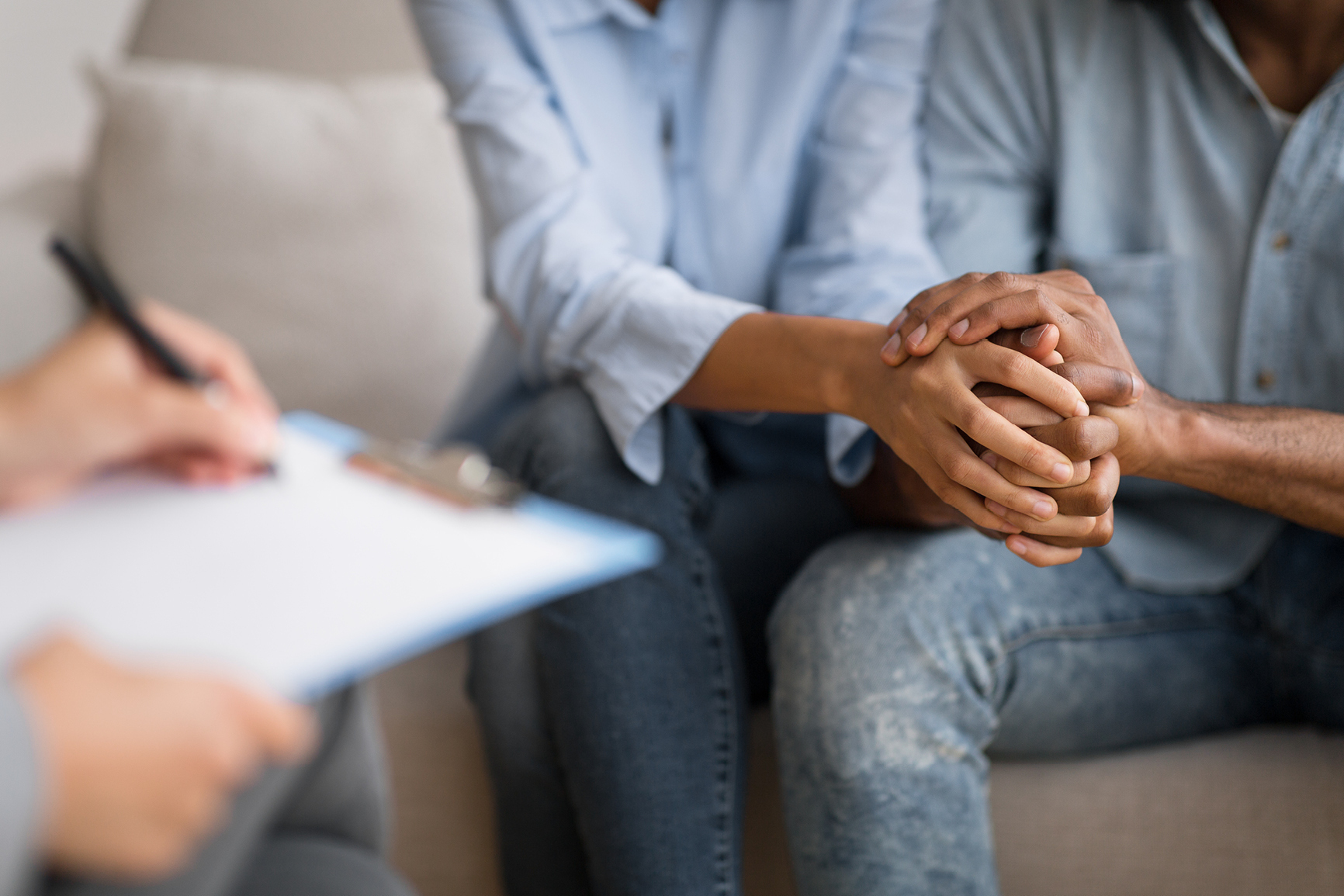 Couple holding hands during counseling session